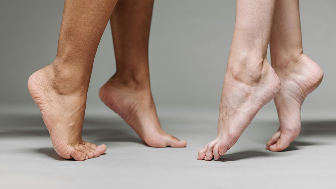 A couple is dancing with their feet.