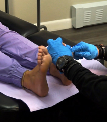 A close up of Dr. Mitchell Wachtel performing delicate foot pain treatment.