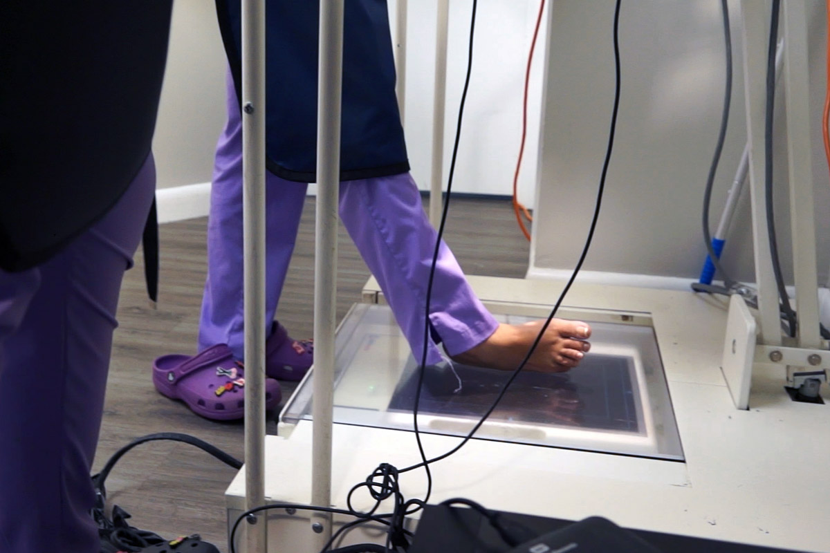 A patient is getting an x-ray of her foot in order to rule out possible causes of heel and ankle pain.