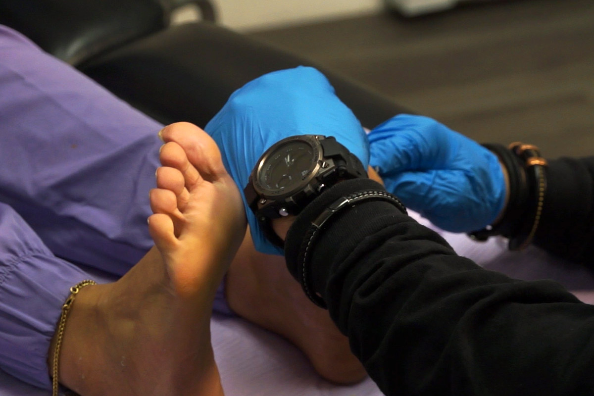 Dr. Mitchell Wachtel is examining a patient's feet with tendon and ankle concerns.
