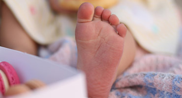 A child's foot is examined.